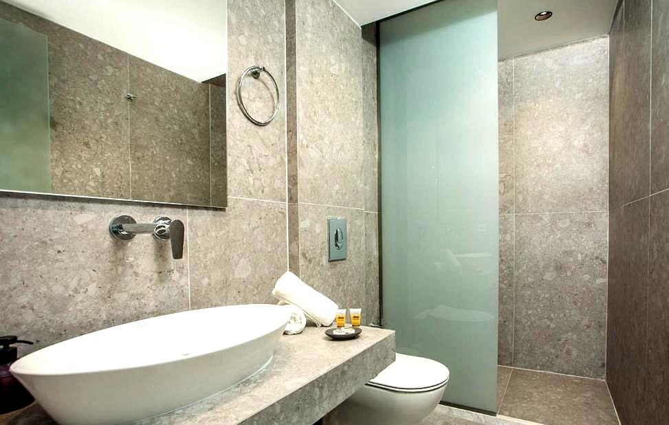 sleek bathroom with grey tiles