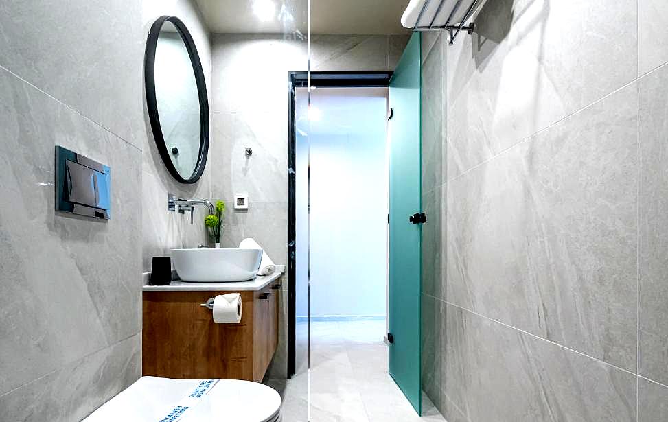 sleek bathroom with round mirror