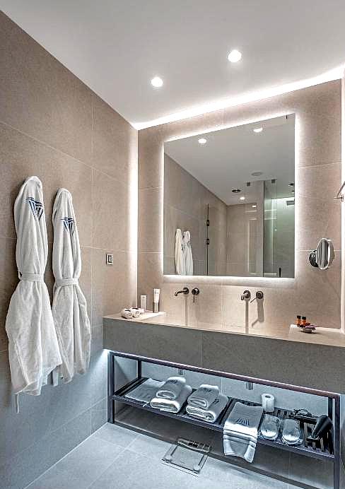 sleek modern bathroom with plush robes