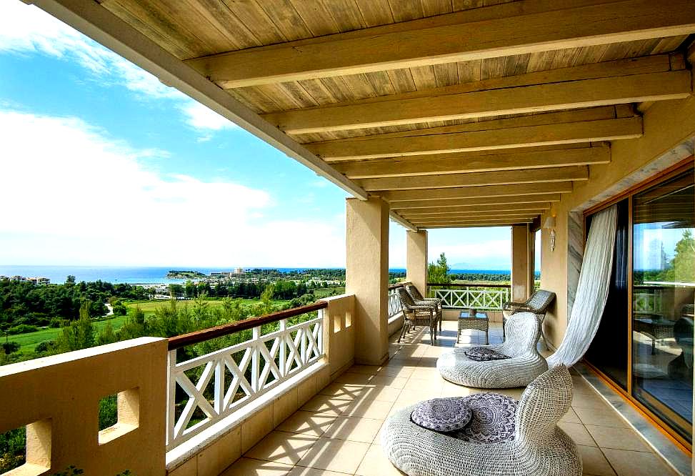 spacious balcony with comfortable seating and sea view