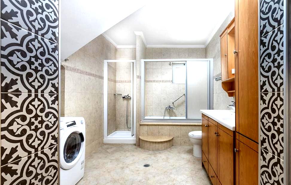 spacious bathroom with modern fixtures and elegant tiles