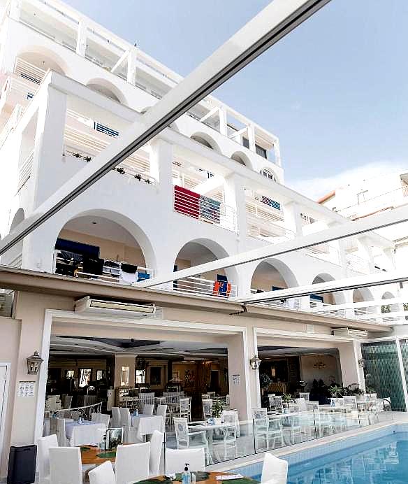 spacious hotel facade with multiple balconies and dining area