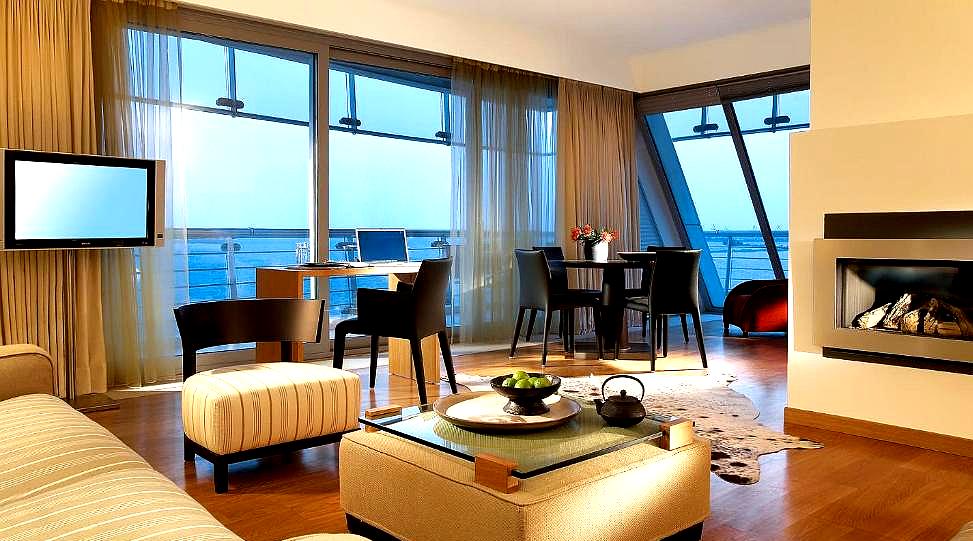 spacious sea view suite with modern furnishings and fireplace