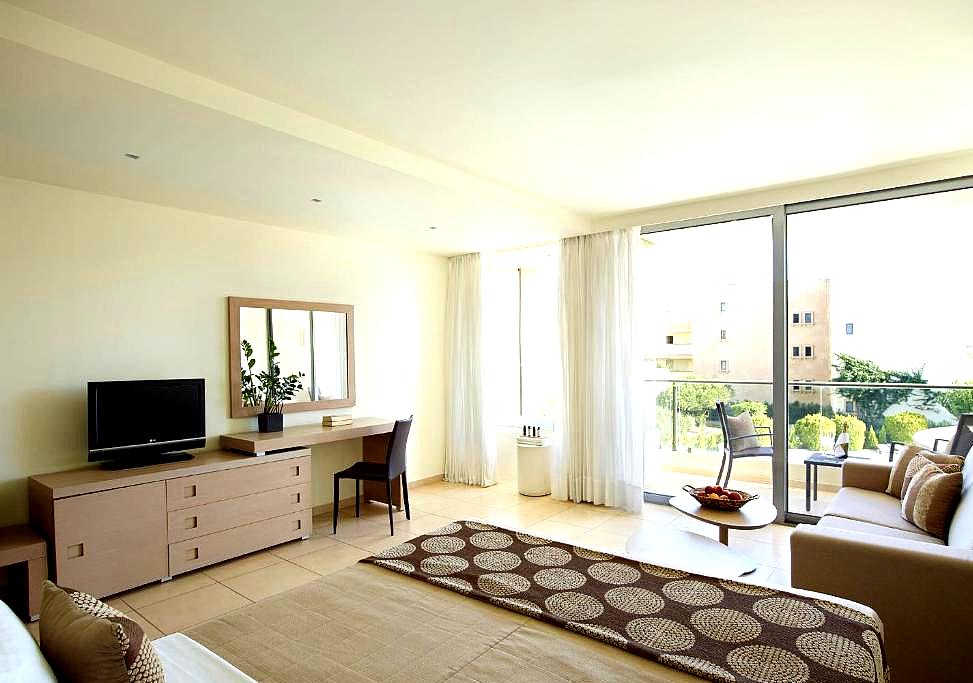 spacious suite with balcony and comfortable seating area