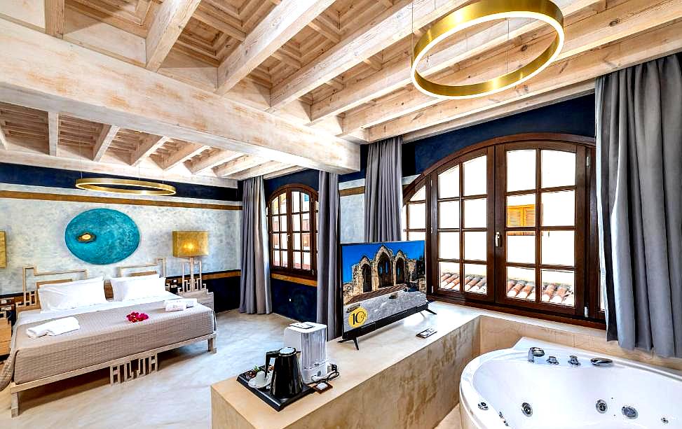 spacious suite with jacuzzi and wooden ceiling