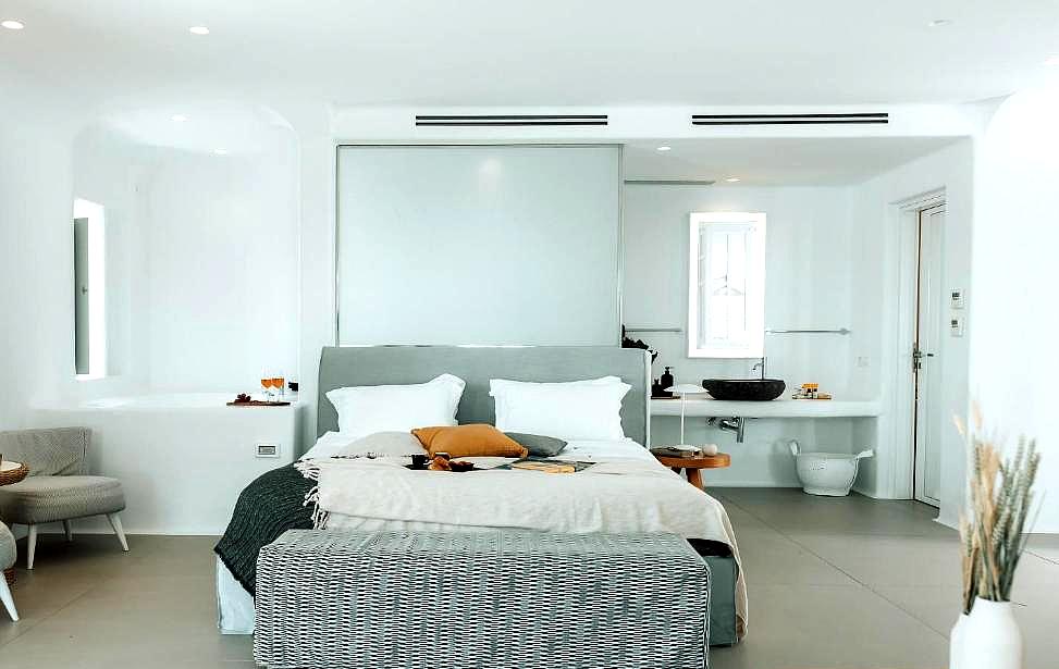 spacious suite with modern minimalist decor and comfy seating