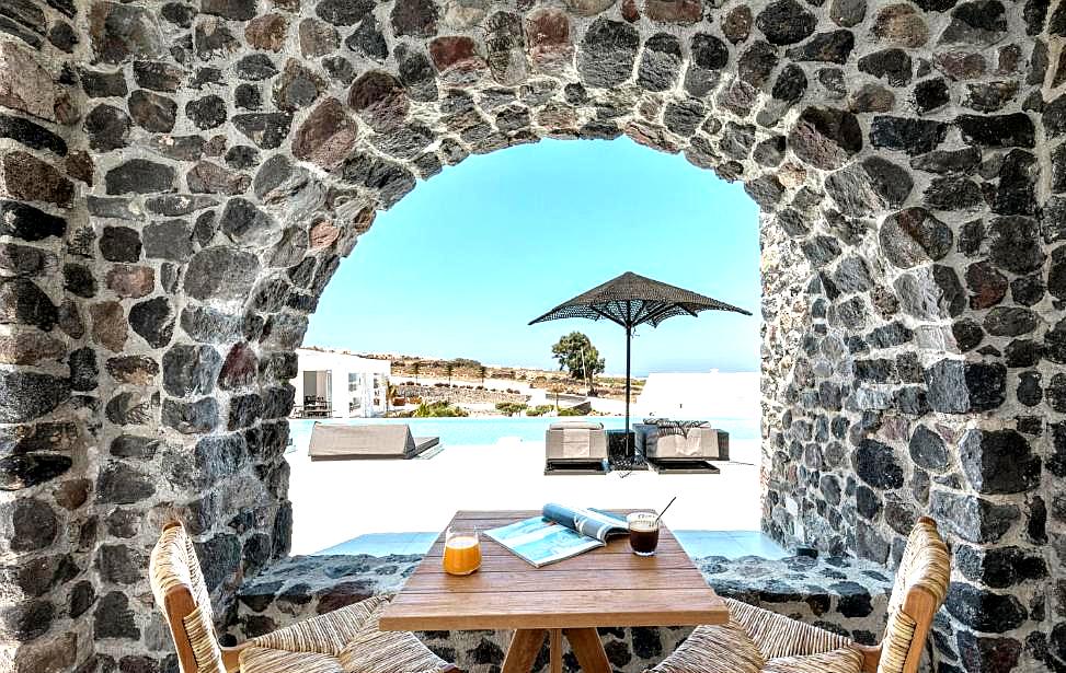 stone arched dining area with pool and sea view