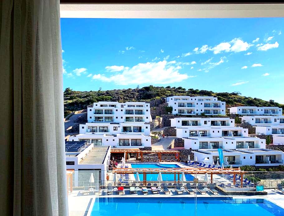 stunning view of pools and sea from room balcony