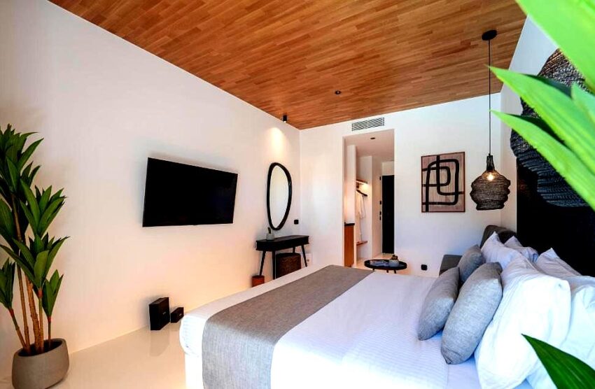 stylish bedroom suite with wooden ceiling and modern amenities