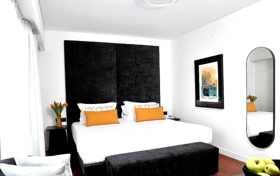 stylish bedroom with bold black accents and modern art