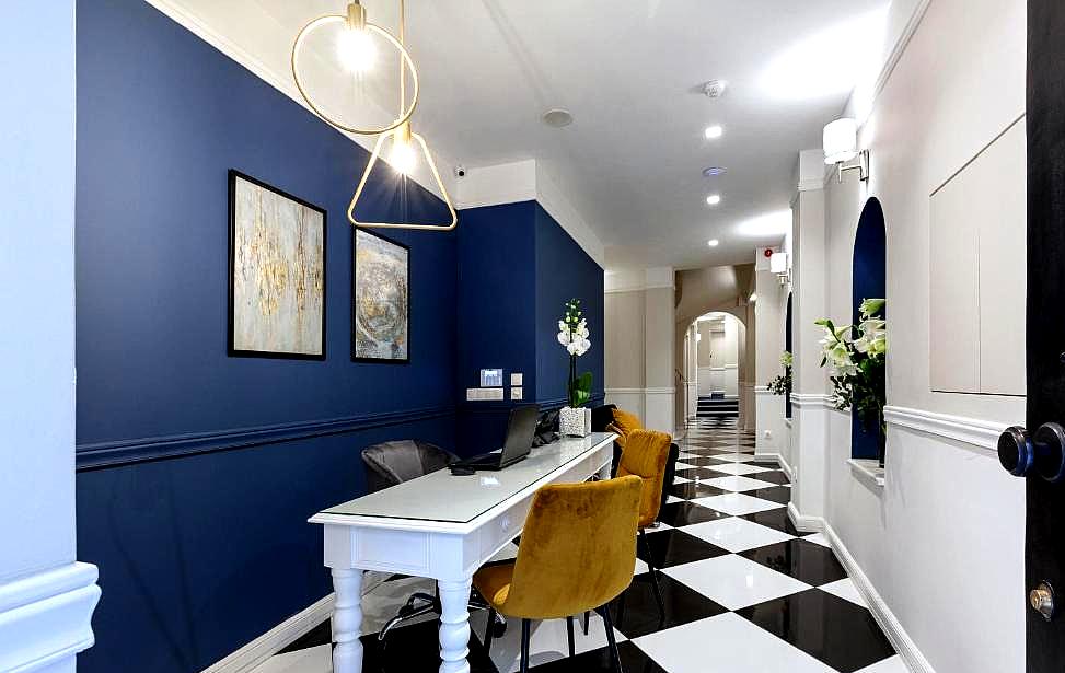 stylish hotel reception area with blue walls and modern lighting