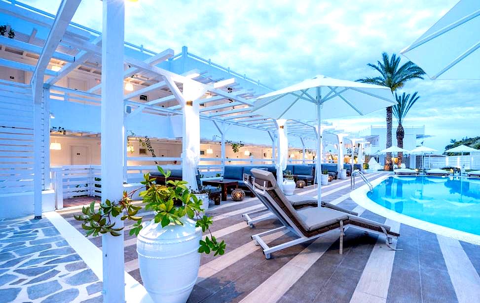 stylish pool area with loungers and white cabanas