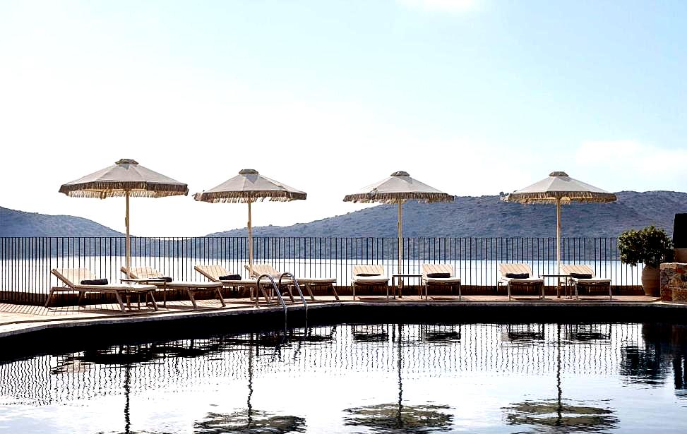 sun loungers with umbrellas overlooking peaceful sea view