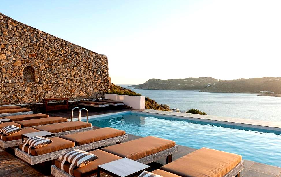 sunbeds by the pool with panoramic sea view