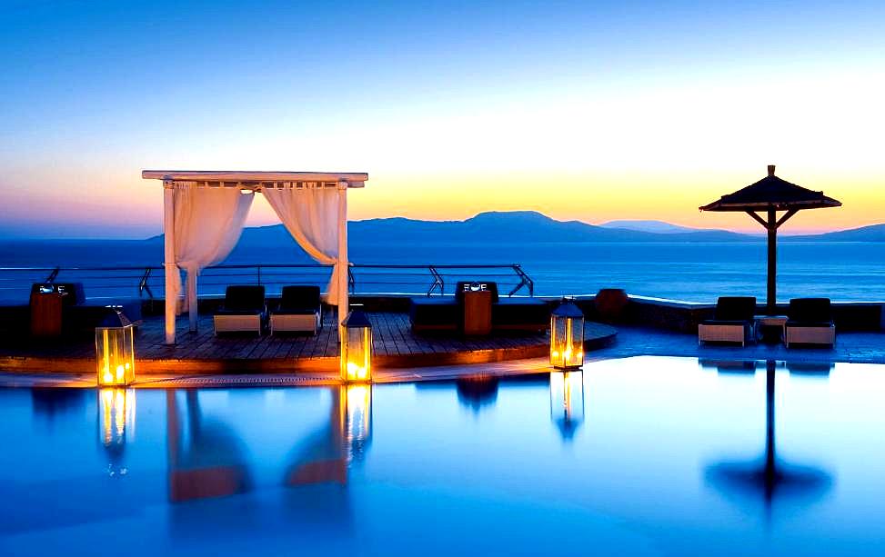 sunset poolside cabana with sea view and mood lighting