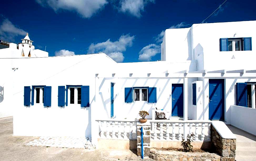 traditional whitewashed hotel facade with blue shutters