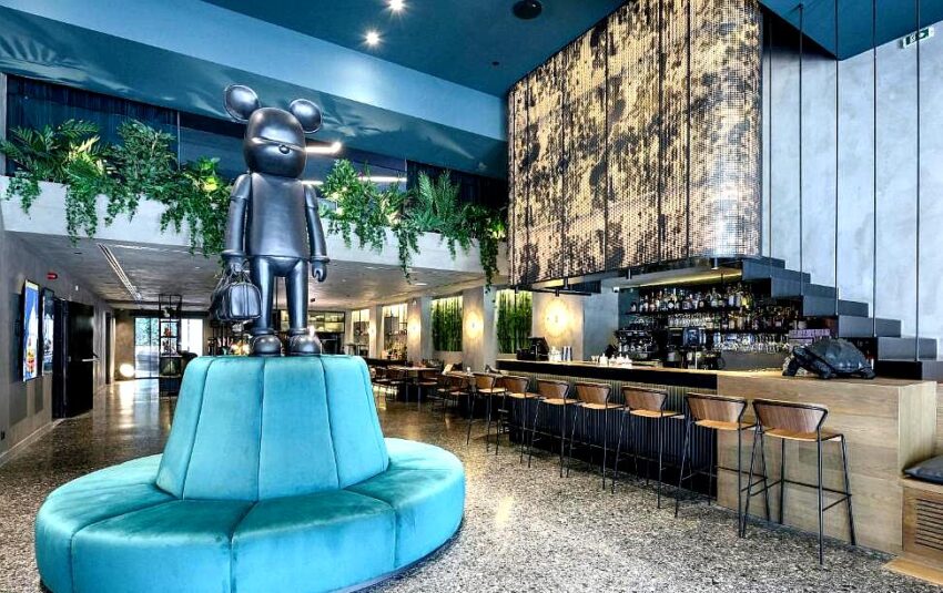 trendy hotel lobby with modern sculpture and bar area