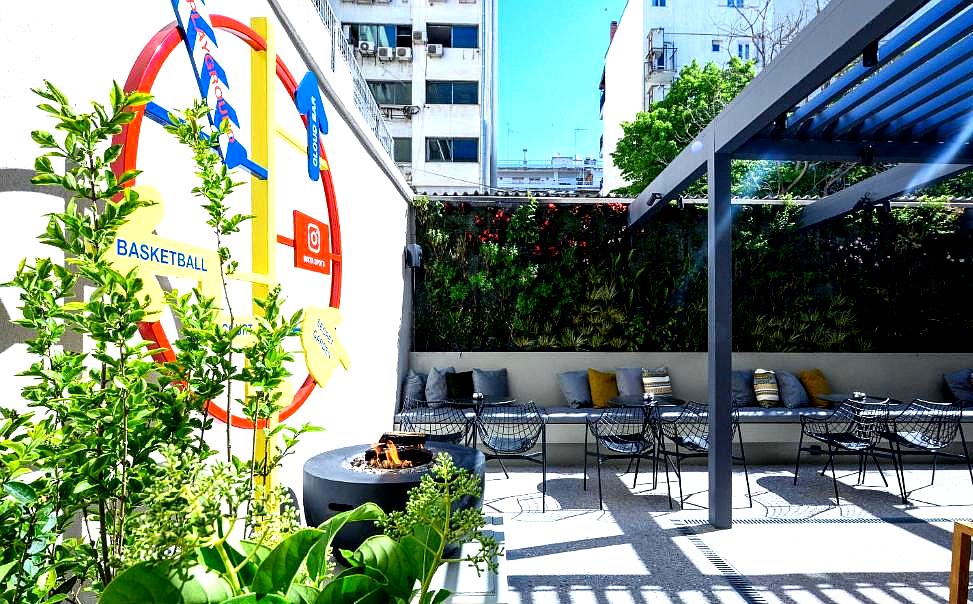 vibrant outdoor patio with seating and wall art