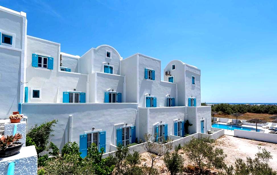 white building with blue shutters and windows